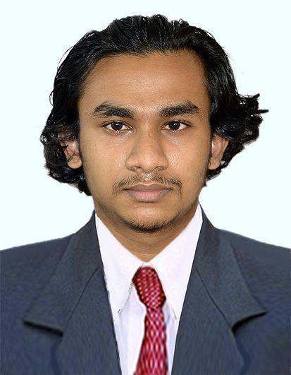 Abhinav Shayish, Design Engineer in dark business suit with white shirt and red patterned tie